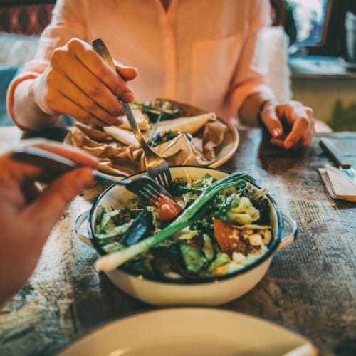 Residents enjoying a meal together at a restaurant near Adobe Flats IV in Twentynine Palms, California