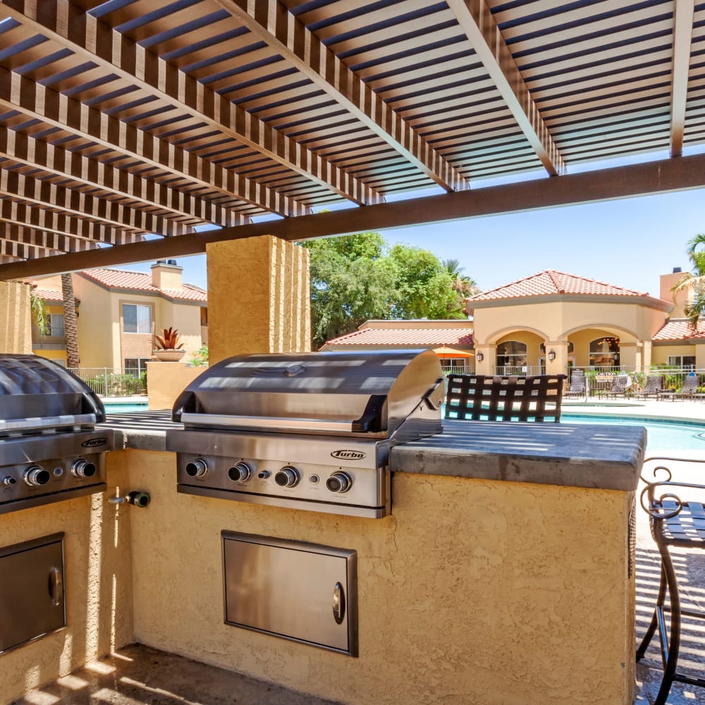 BBQ grilling area by the pool at Tresa at Arrowhead Apartments in Glendale, Arizona