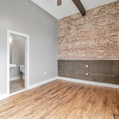 A spacious bedroom with wood-style flooring at Barcalo Living in Buffalo, New York