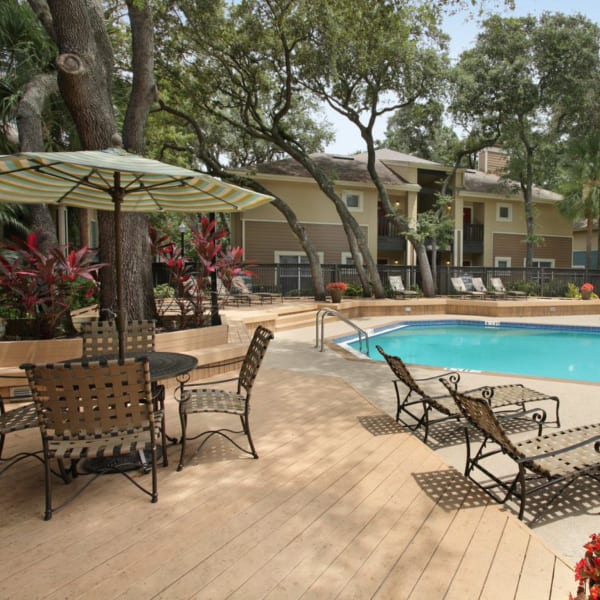 Chaise lounge chairs around the pool at Park East Apartments in Tampa, Florida