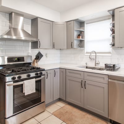 Ultra-modern kitchen with an expansive quartz countertop in a model luxury apartment at Mariposa at Bay Colony in Dickinson, Texas