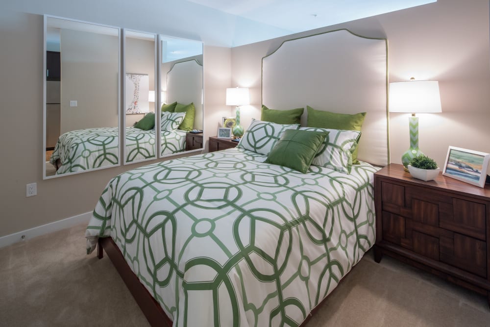 Cute bedroom with green and white decor on the bed at The Tala at Washington Hill in Baltimore, Maryland