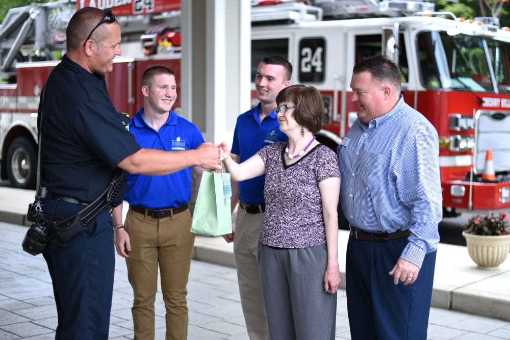 Community executive director shaking hands with firefighter