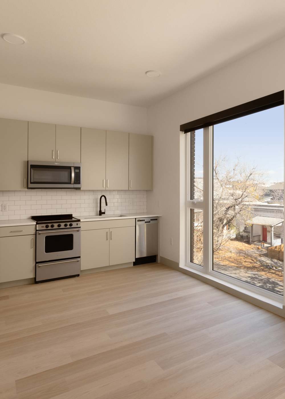 Spacious kitchen with wood-style flooring at Accent LoHi in Denver, Colorado