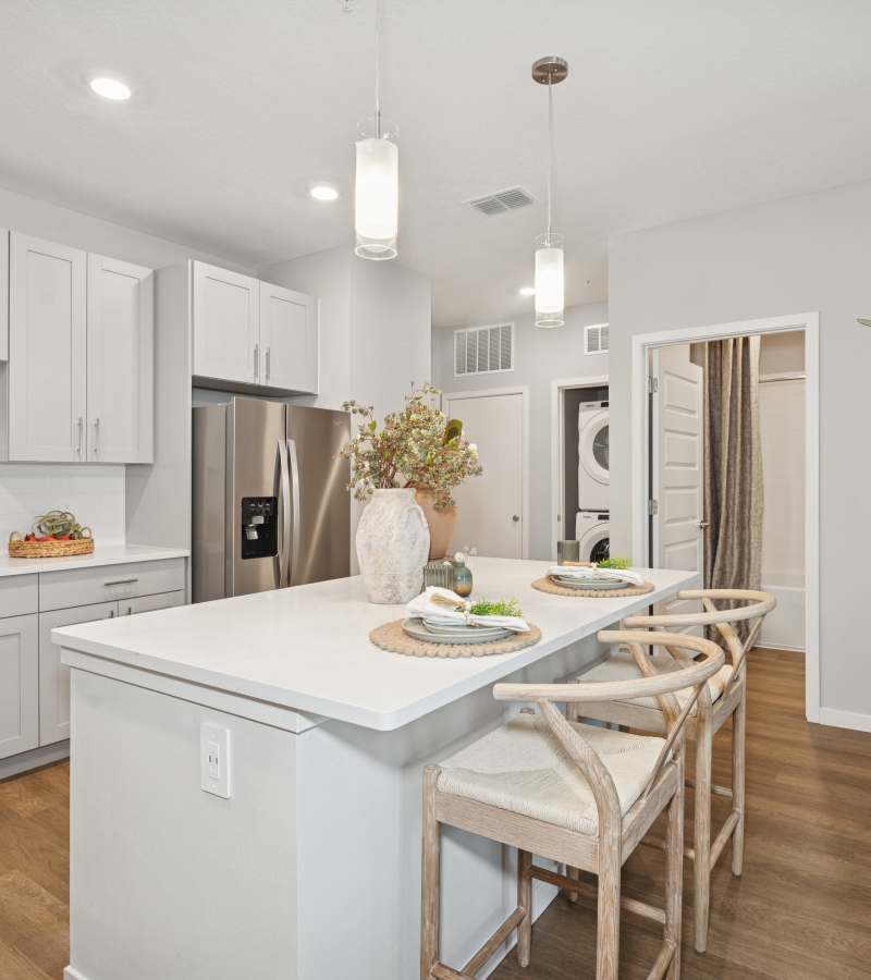 Kitchen island and stainless-steel appliances in a home at Savelle Nona West in Orlando, Florida