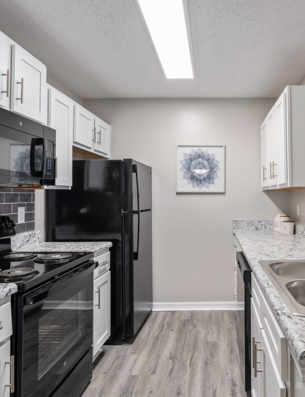 Kitchen with black appliances at Regency Gates in Mobile, Alabama