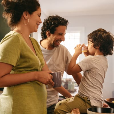 Family eating breakfast together in their kitchen at James River Pointe in Richmond, Virginia