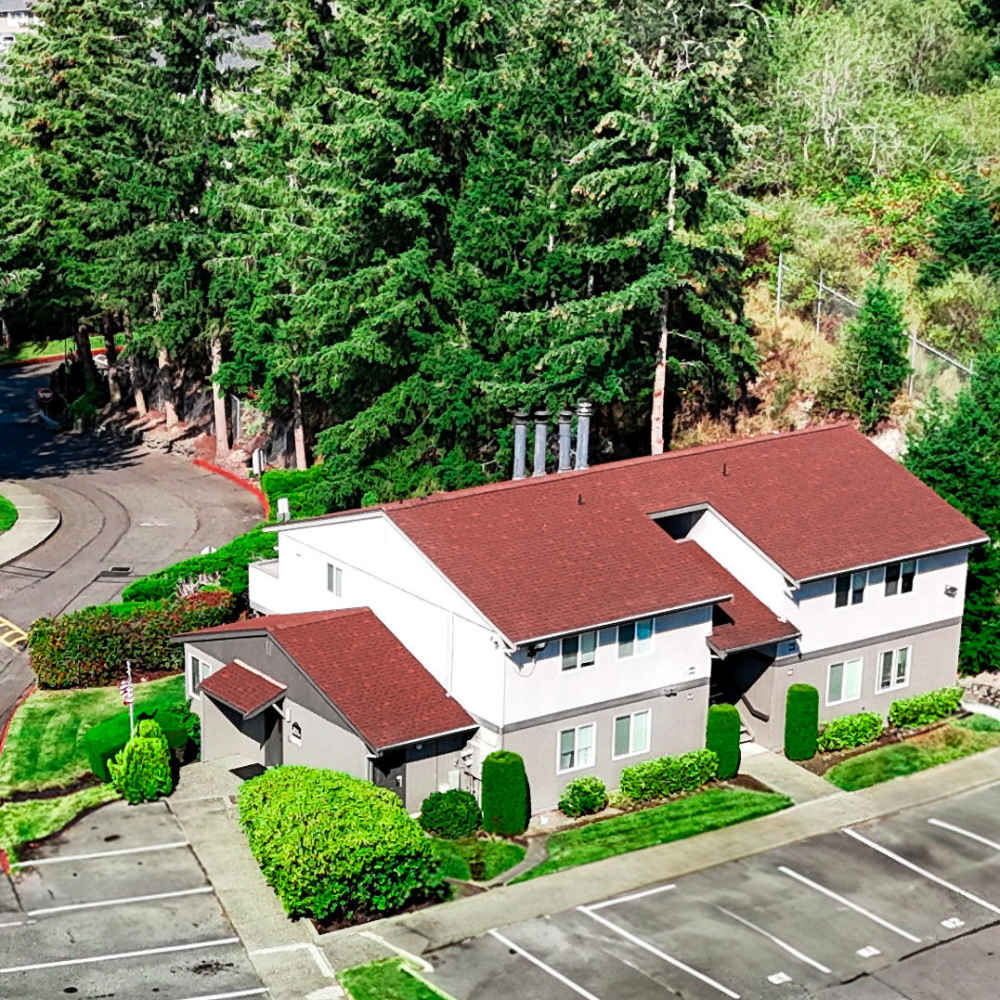 White building with a red roof at Cheyenne Place in Tacoma, Washington