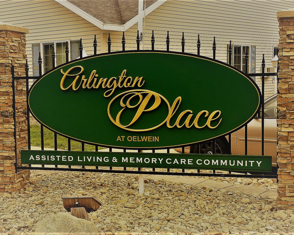 Signage in a bed of rocks at Arlington Place Oelwein in Oelwein, Iowa.