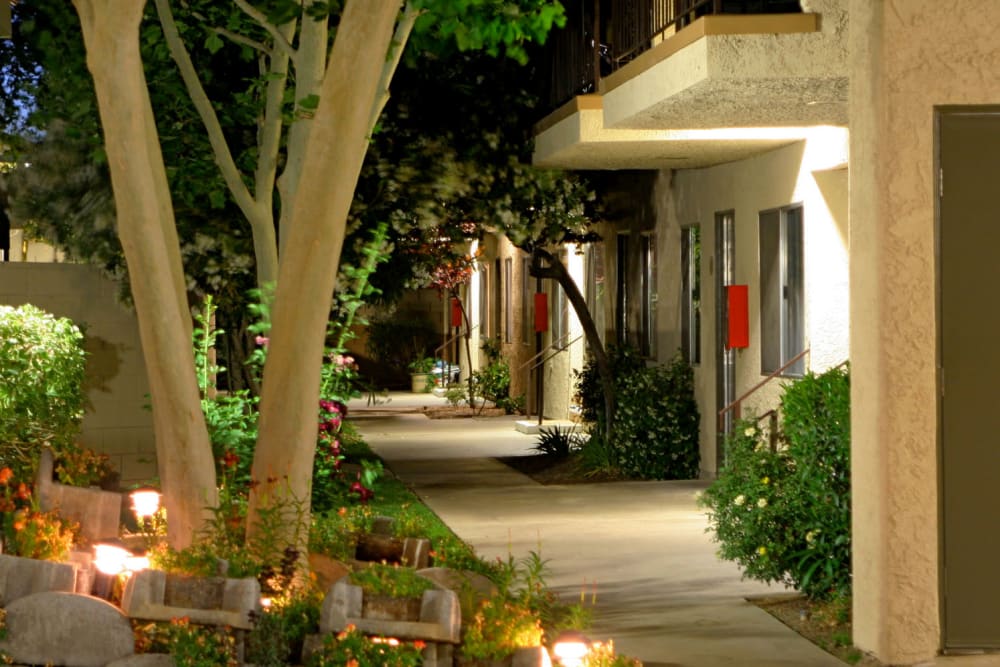 Evening lights illuminating flowers outside resident apartments at Parkwood in Lancaster, California
