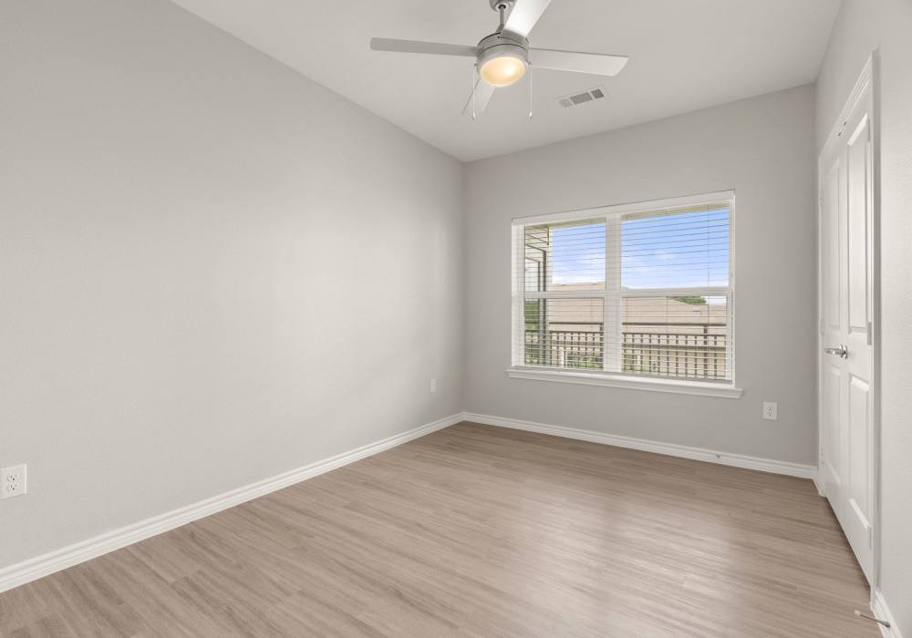 Bedroom with large window at Walnut Springs in Seguin, Texas