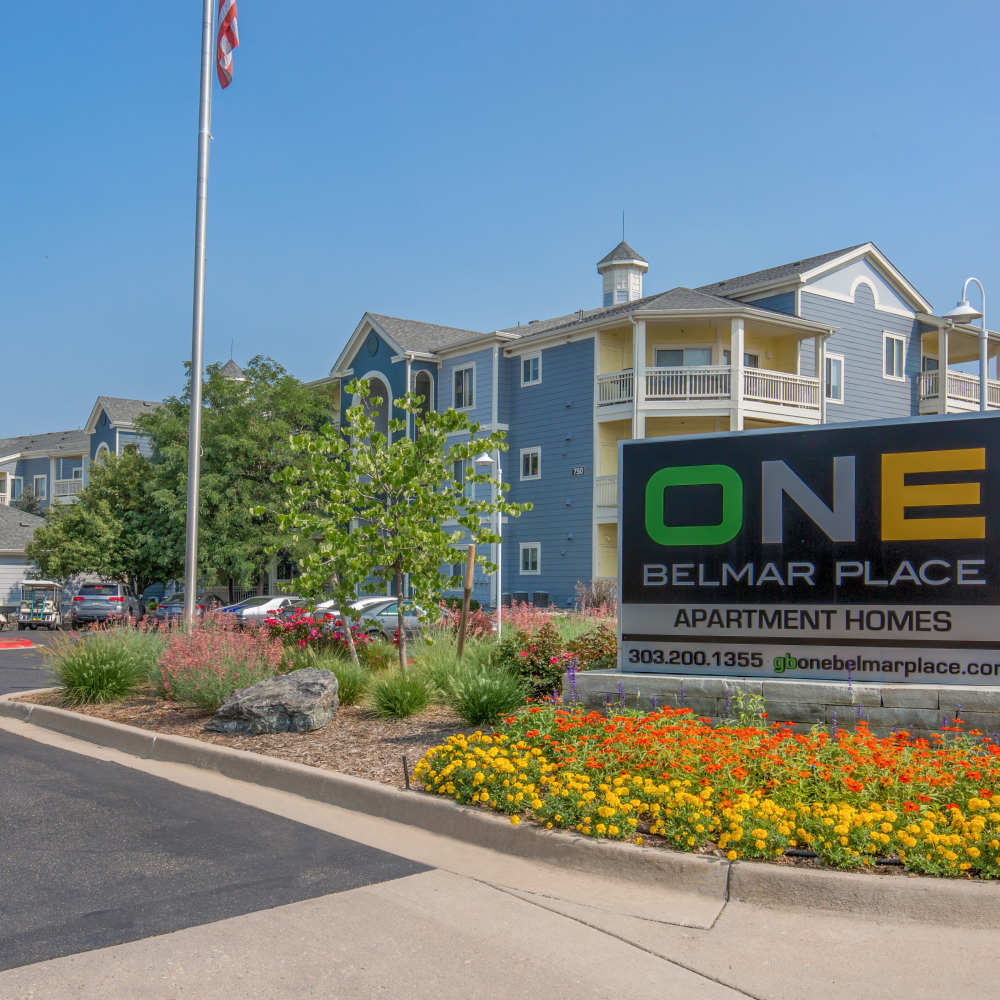 Community signage with view of apartment at One Belmar Place in Lakewood, Colorado