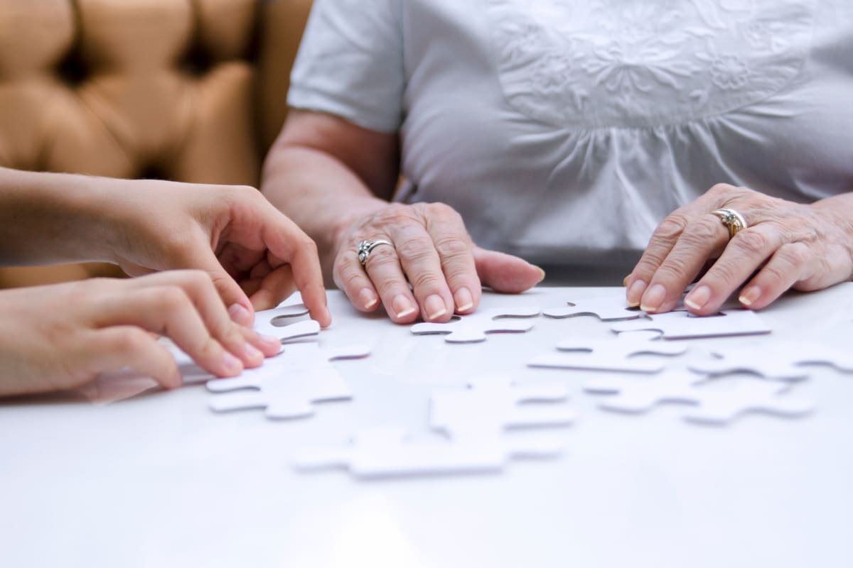 Residents solving a puzzle at Glen Carr House Memory Care in Derby, Kansas