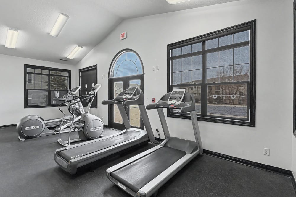Modern fitness center with ample equipment and bright windows at Pointe 28 in Ankeny, Iowa.