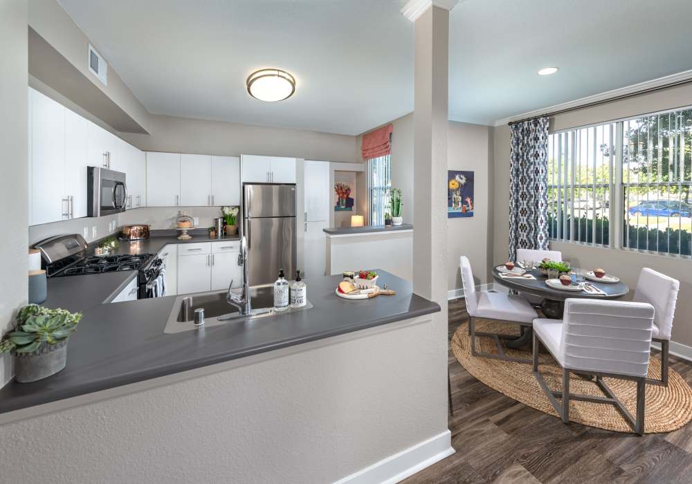 Well-furnished kitchen with white cabinets at Park Hacienda Apartments in Pleasanton, California