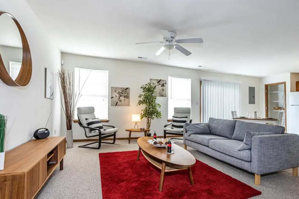 Large modern living room with sofas, coffee table and fan at Cross Creek Villas in Columbia, Missouri