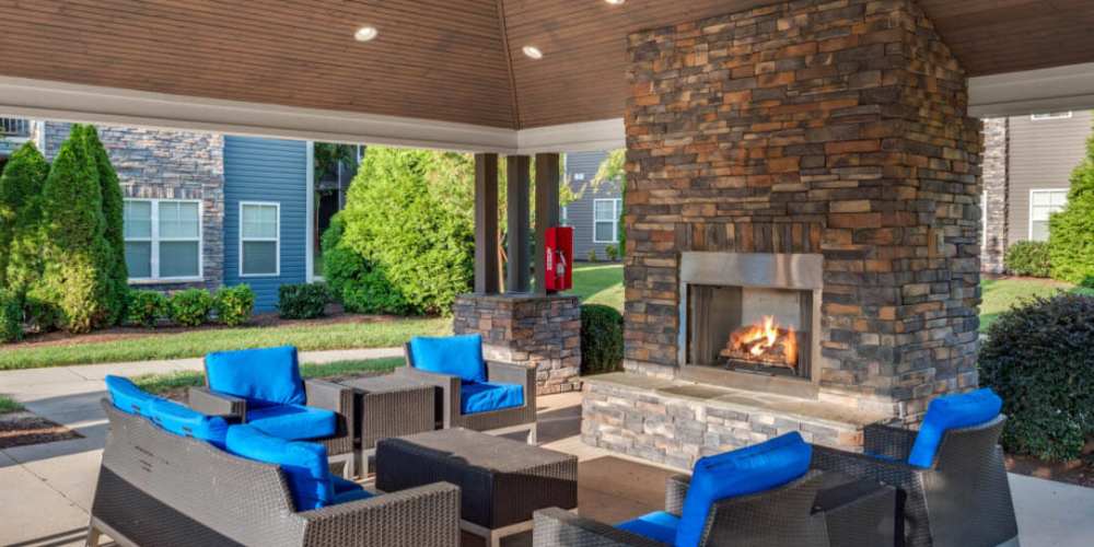 Outdoor lounge by the fireplace at Bridford West in Greensboro, North Carolina
