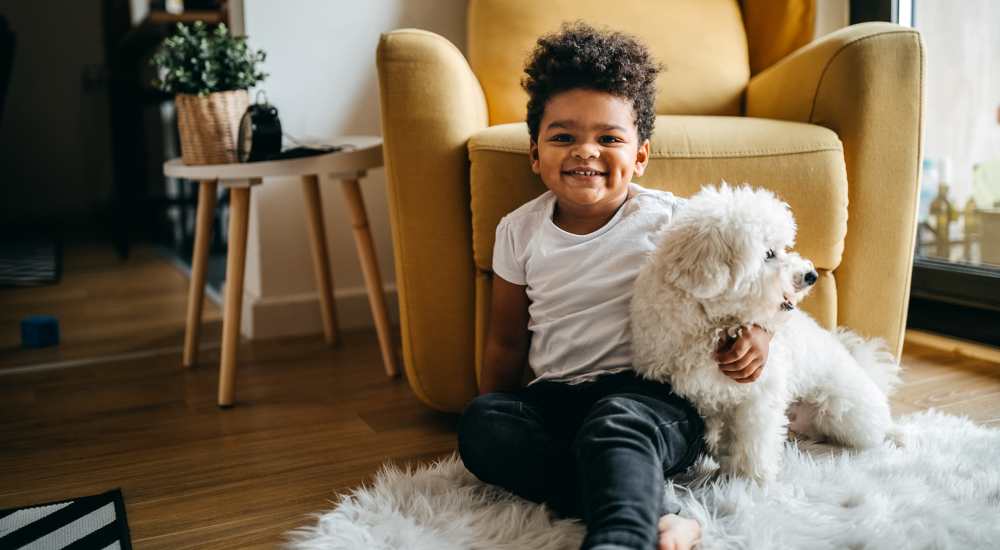 A young kid with his dog at Newport Avenue Apartments in Rumford, Rhode Island