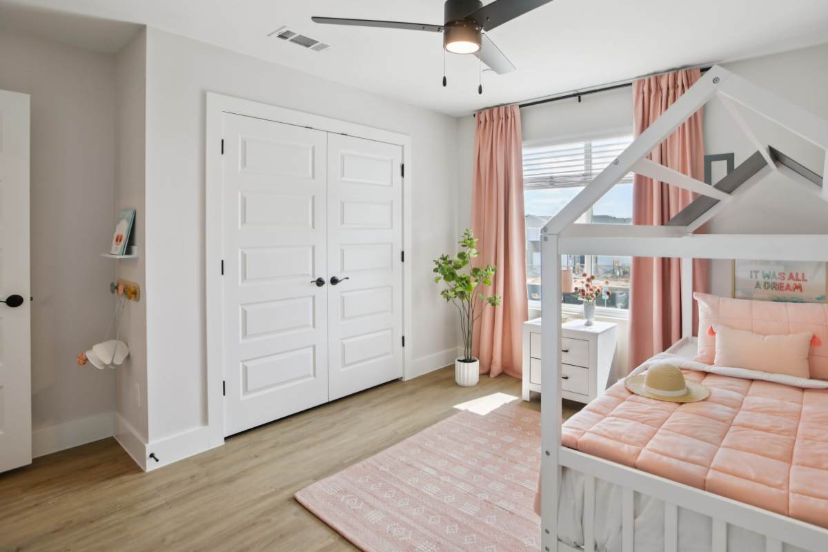 Bedroom with pink bed with a built-in closet at BB Living Sweetwater Crossing in Bee Cave, Texas