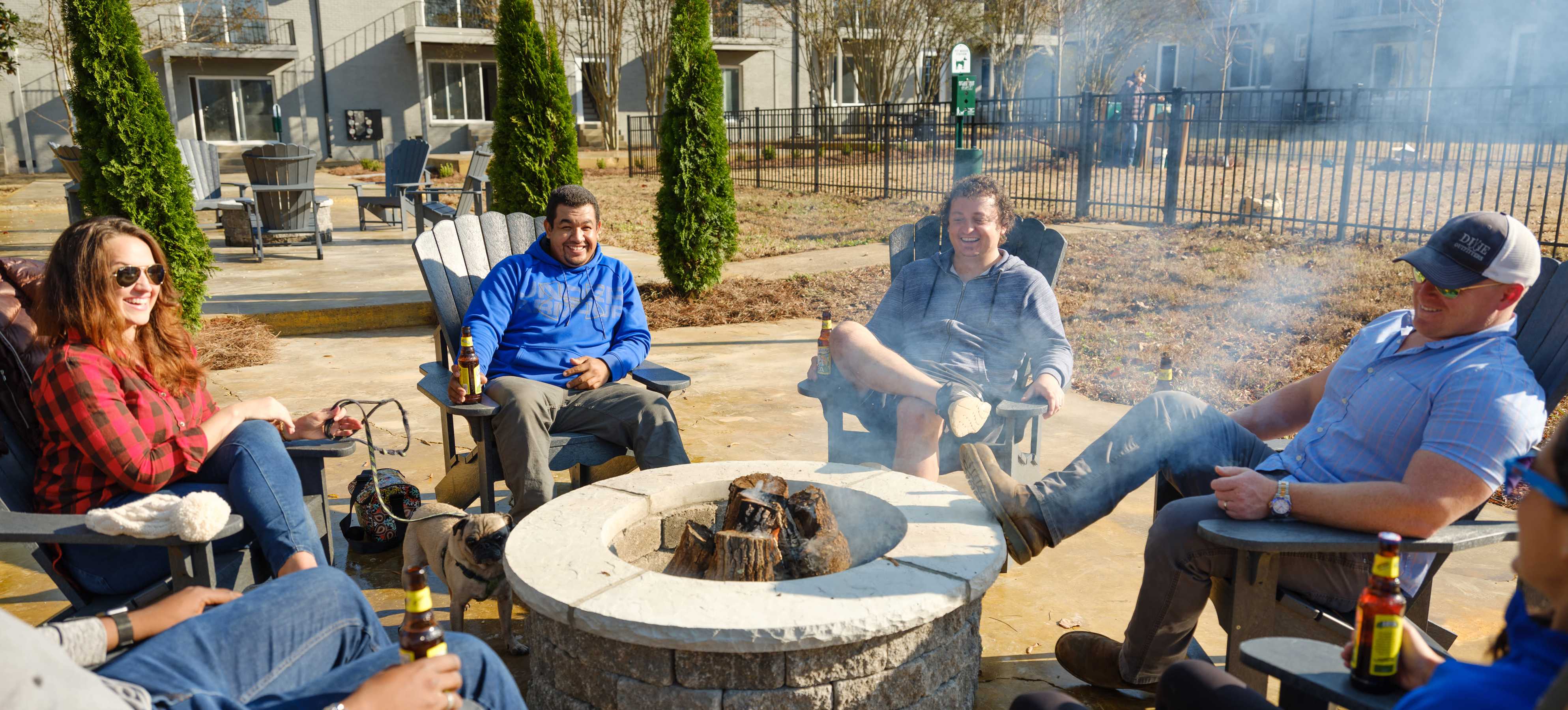 Residents enjoying around firepit at Midtown Square Chattanooga Apartments in Chattanooga, Tennessee.
