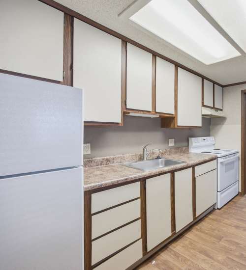 Kitchen with dual tone cabinetry at Live Grove City in Grove City, Ohio