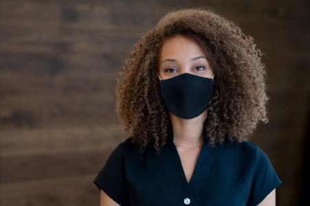 Young woman wearing a mask in response to COVID-19