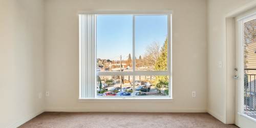 Bedroom with a window at North Main Village in Milwaukie, Oregon