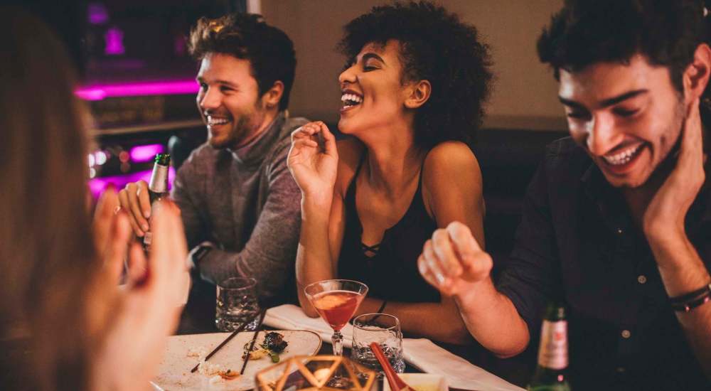 Residents having delicious food and drink at a restaurant near Lincoln Court Apartments in Dallas, Texas