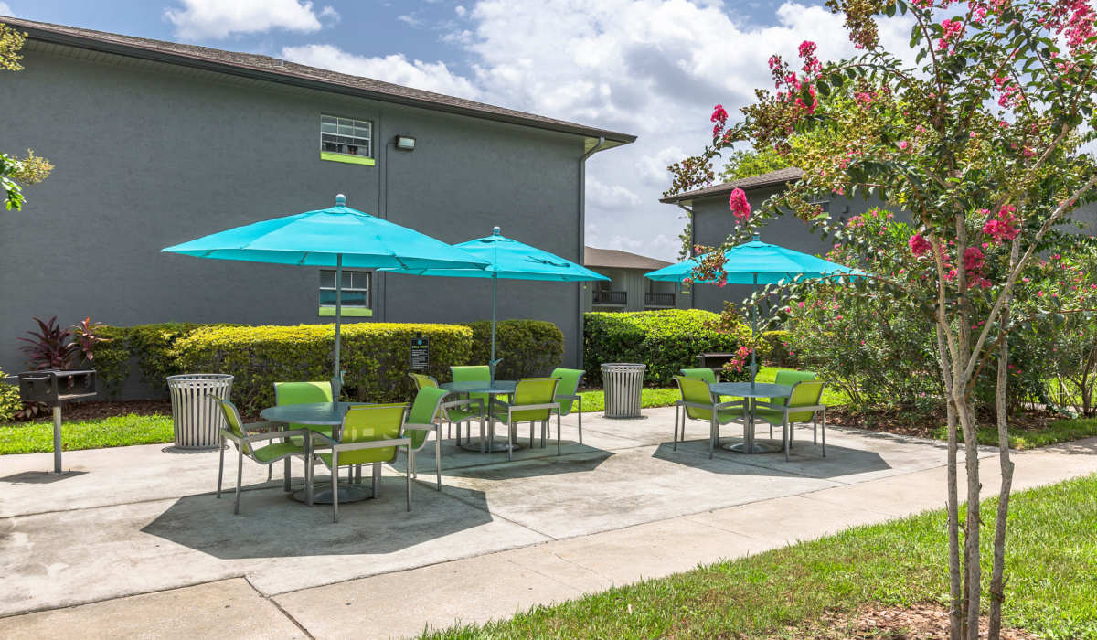 Community patio with covered umbrella seating at Central Place at Winter Park in Winter Park, Florida