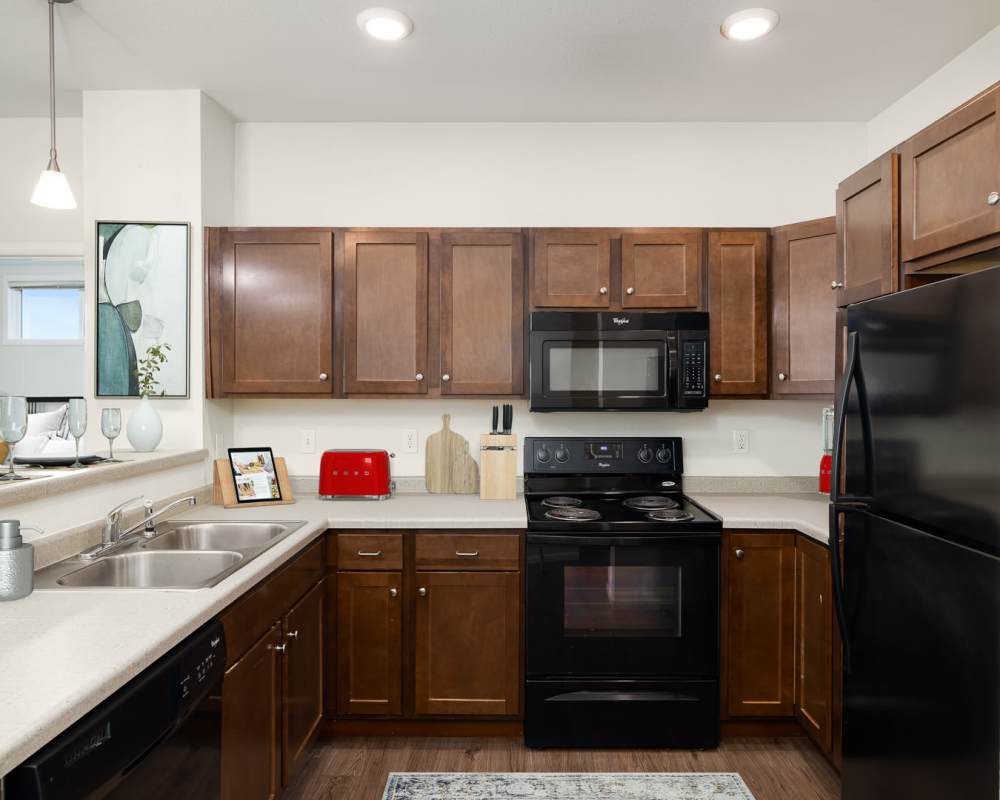 Kitchen with wood-style flooring at Regency Apartment Homes in Williston, North Dakota