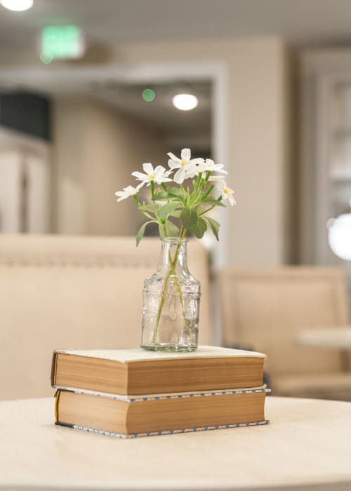 Beautiful vase of flowers on a stack of books at The Pillars of Lakeville in Lakeville, Minnesota