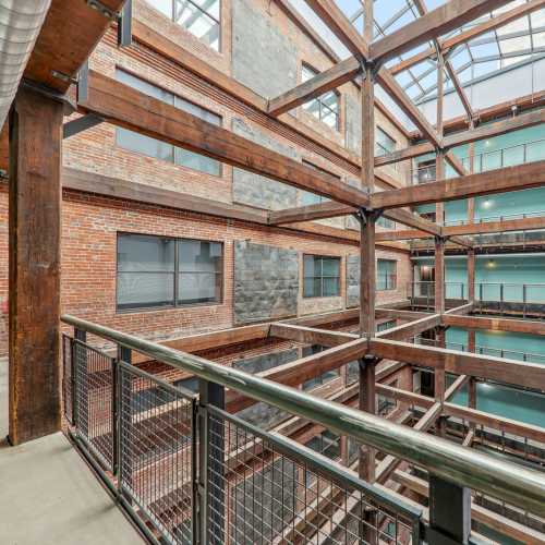 Atrium of community building featuring a balcony and large windows at Stadium Loft Apartments in Saint Louis, Missouri