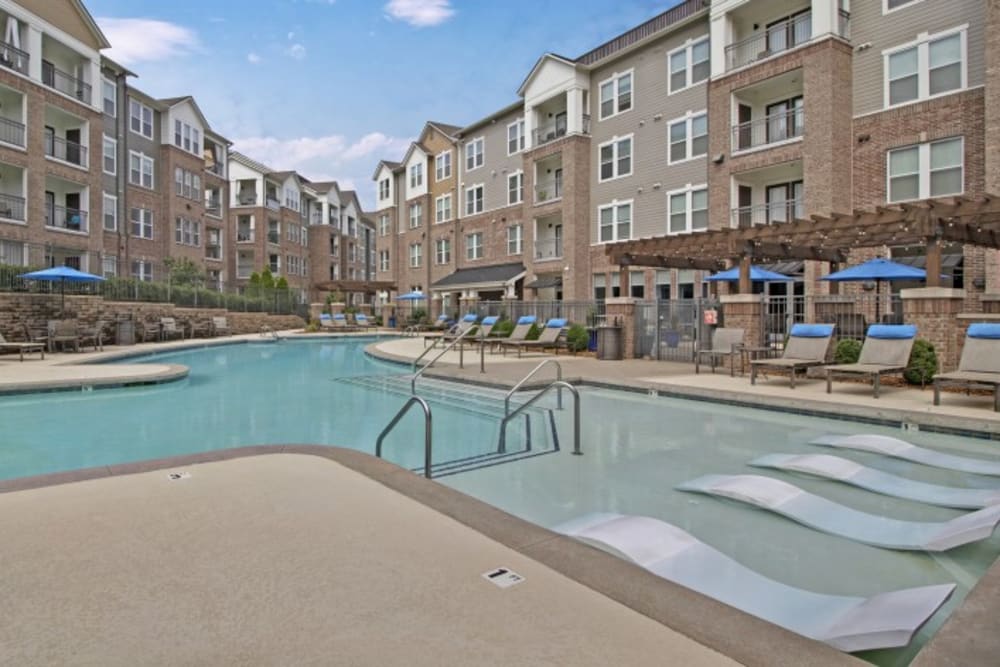 Resort-style swimming pool with sundeck lounge chairs at Artessa in Franklin, Tennessee