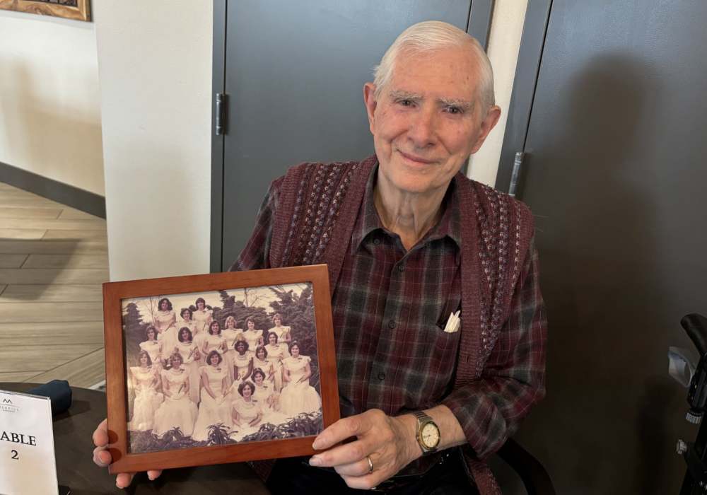 Resident showing an old photo at Merrill Gardens at Wright Park in Tacoma, Washington