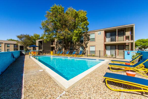 Swimming pool and patio furniture at Sundance Apartments in College Station, Texas