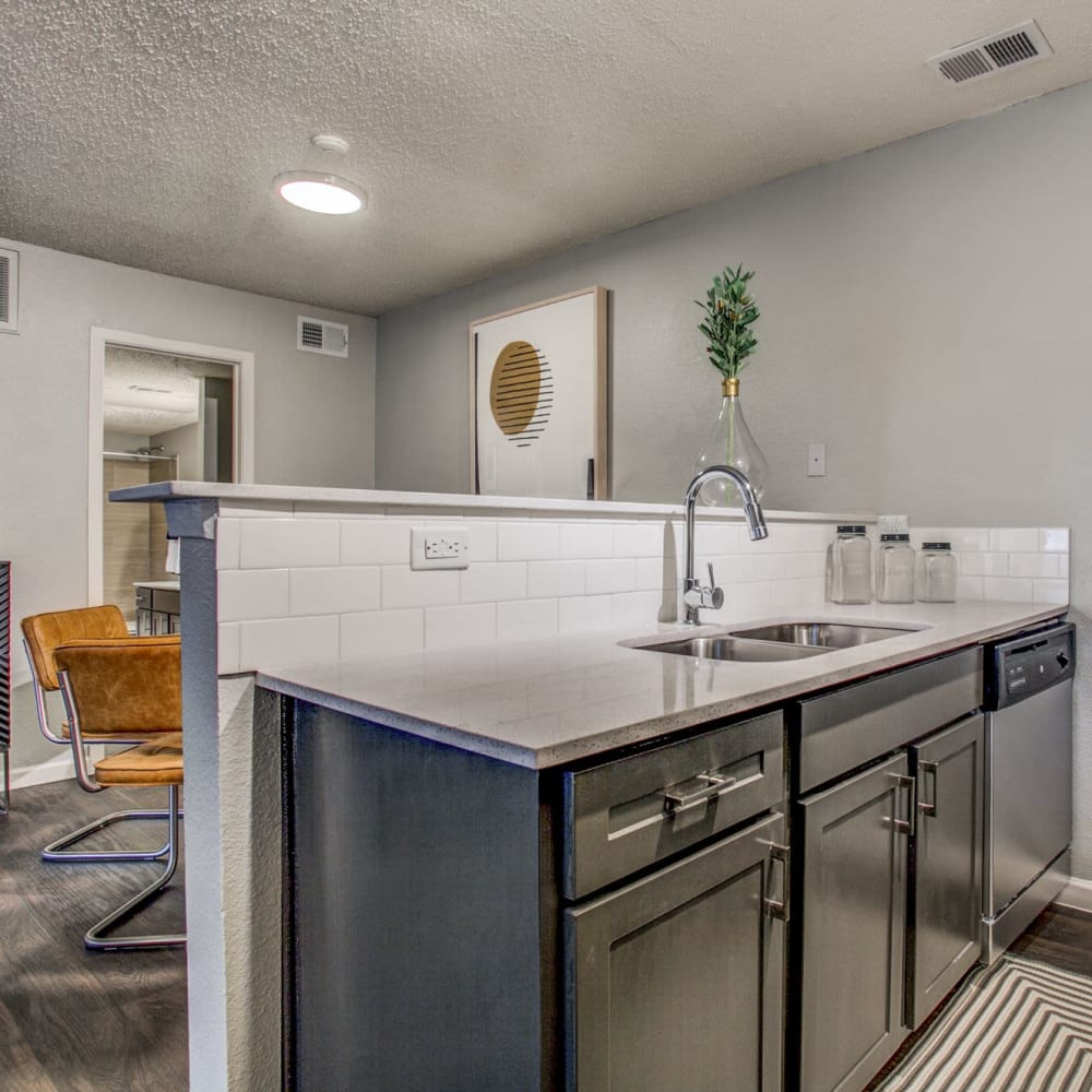 Resident bedroom with wood-style flooring at The Reese at Eastchase in Fort Worth, Texas