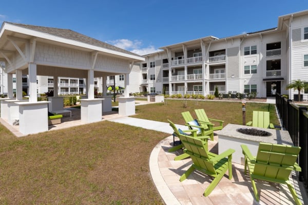 Exterior of apartment homes and outdoor seating lounge at The Iris at Northpointe in Lutz, Florida