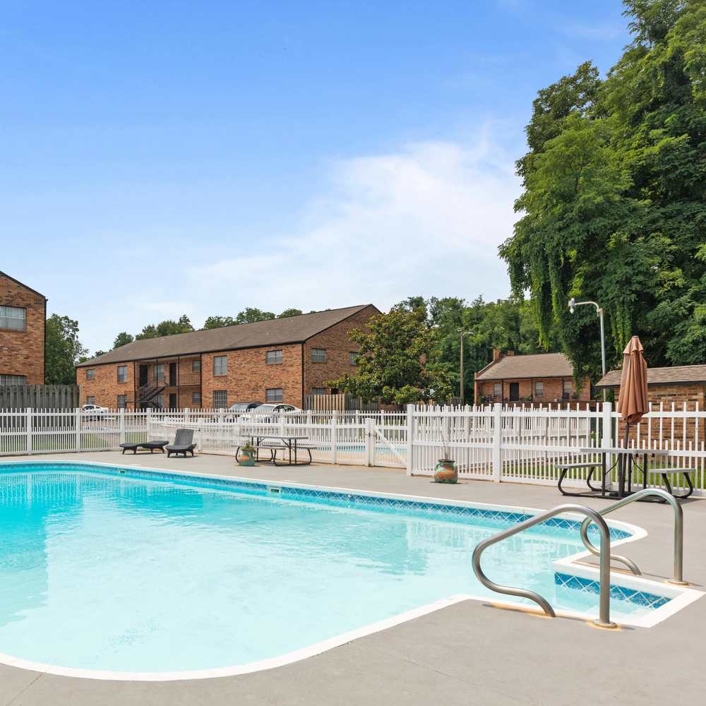 Sparkling water pool surrounded by lush landscaping at Pecan Ridge in Vicksburg, Mississippi.