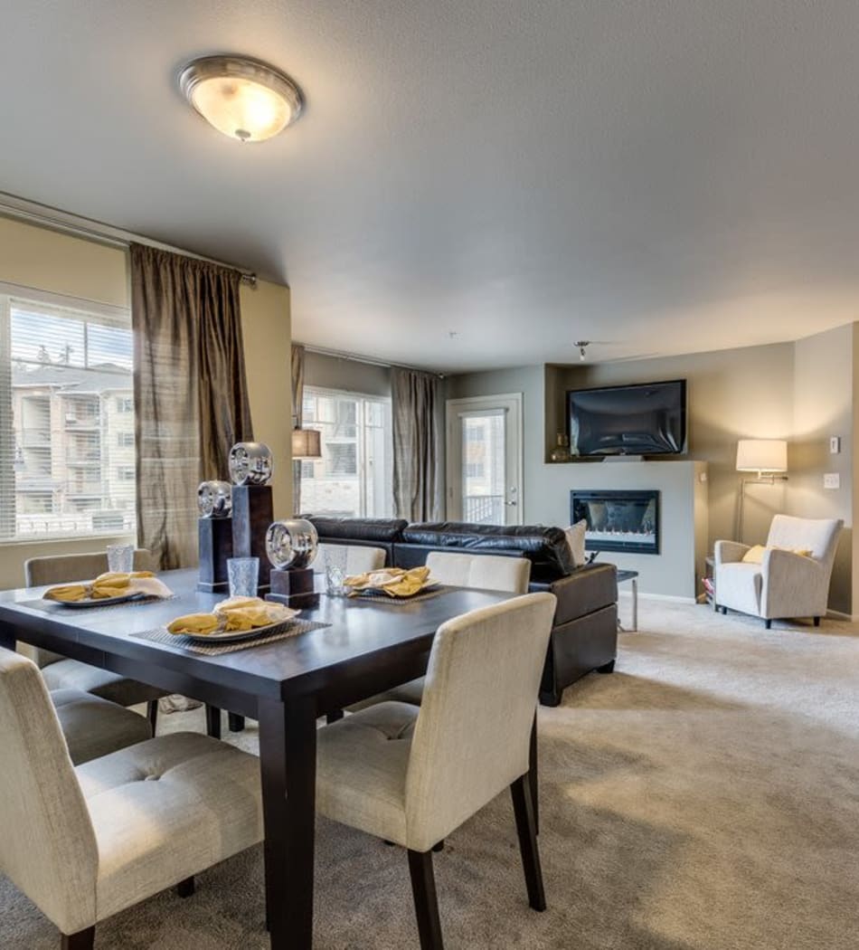 Open-concept living area with a fireplace in a model home at Vue Issaquah in Issaquah, Washington