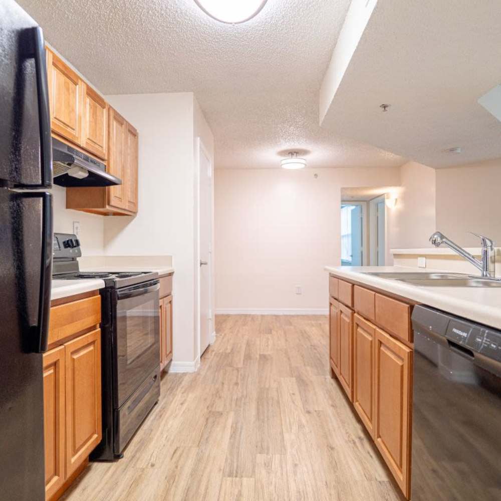 Modern kitchen with wooden cabinets at Logan Heights in Sanford, Florida