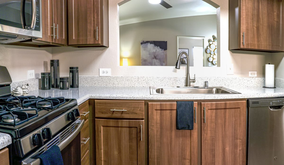 Model kitchen with stainless appliances at La Serena at the Parque in North Las Vegas, Nevada