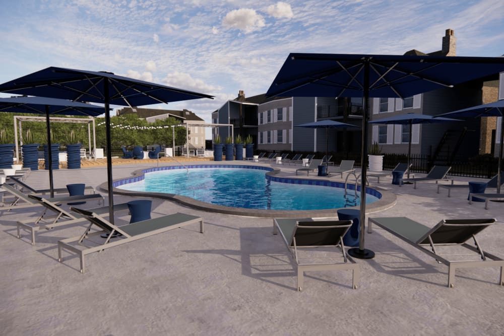Our luxurious swimming pool with lounge chairs and sun umbrellas at The Emory in Pensacola, Florida