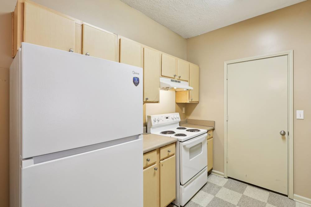 Modern kitchen with white appliances at Camden Park in Canton, Mississippi