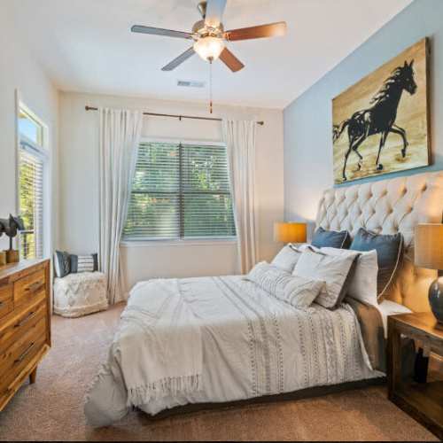 Modern bedroom with large windows at Lodge at Lake Wylie in Lake Wylie, South Carolina