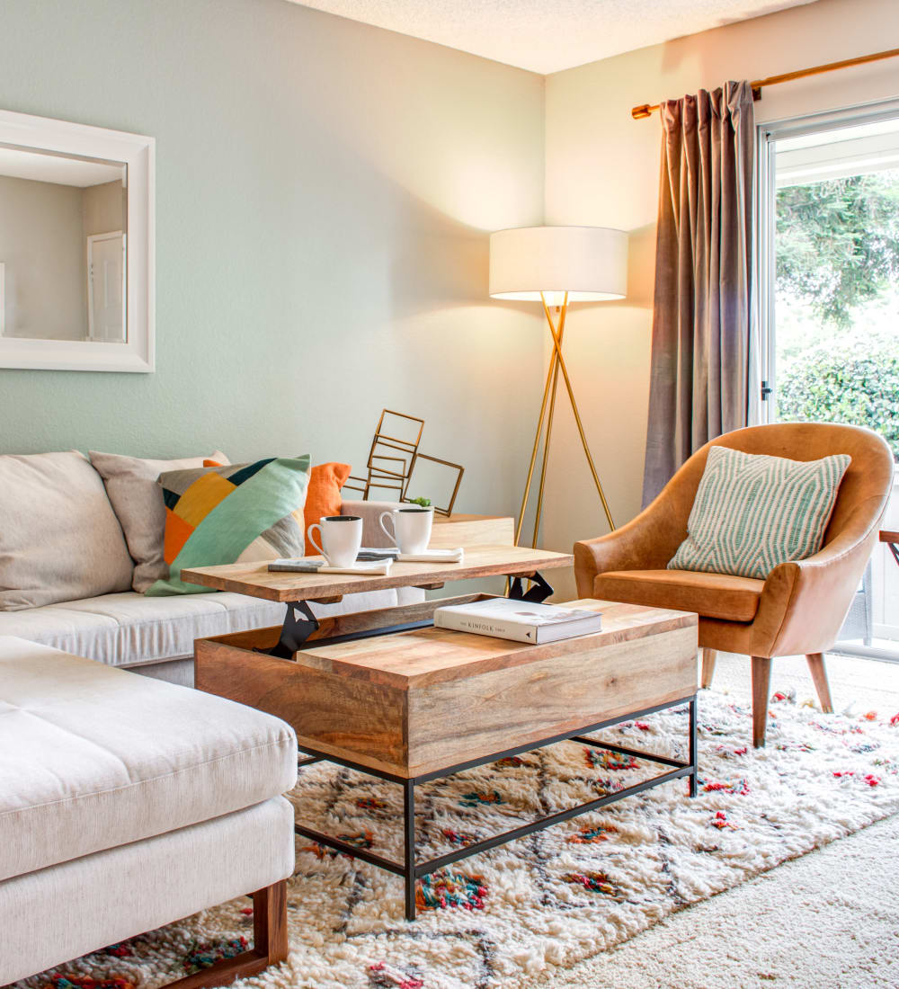 Comfortably decorated living area with draped windows in a model home at Sofi Dublin in Dublin, California