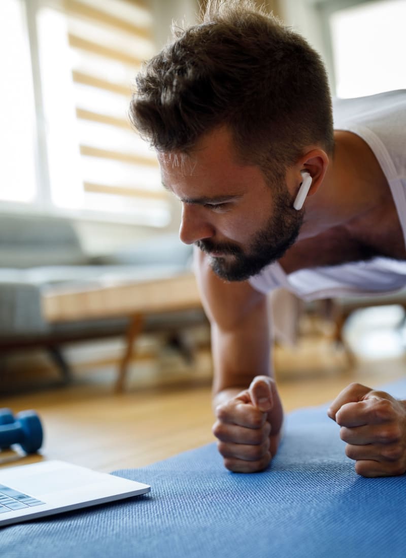 Resident exercising in his living room at Marquis at Silver Oaks in Grapevine, Texas