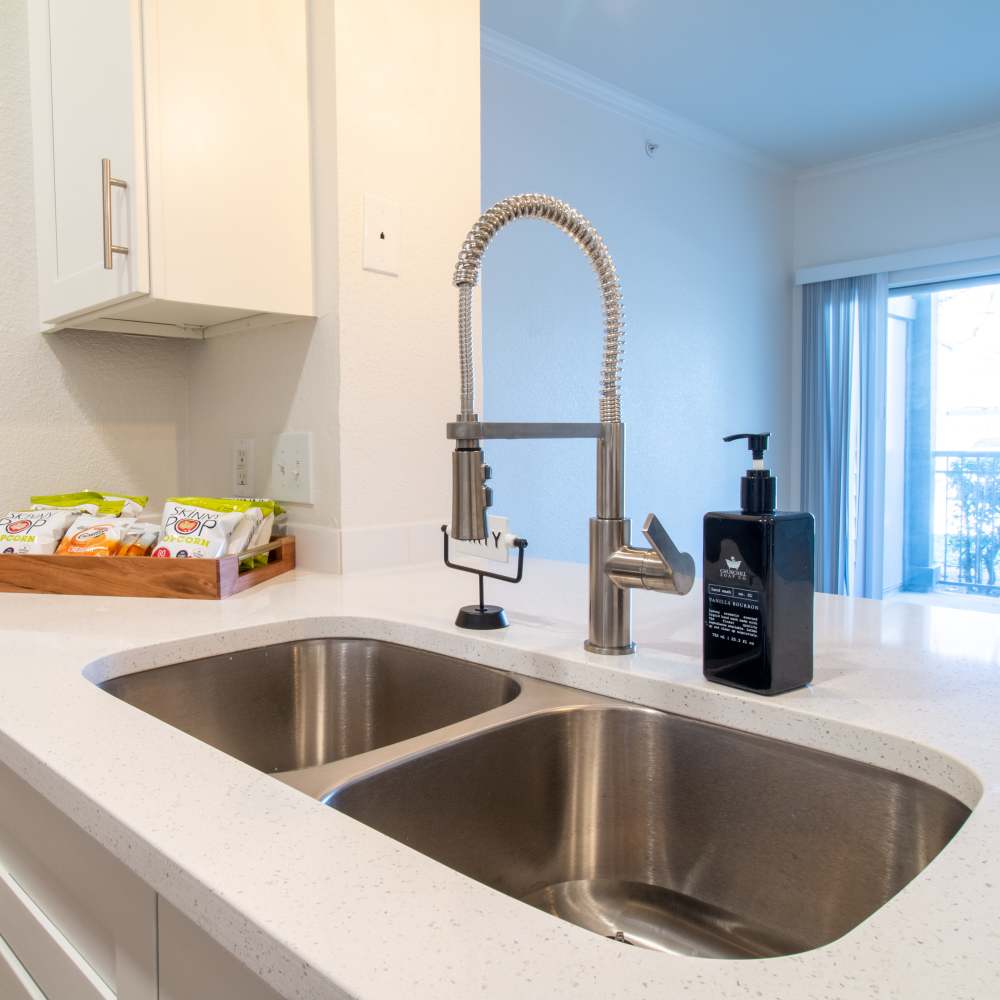 Bright kitchen with stainless steel sink at Sutton in Austin, Texas