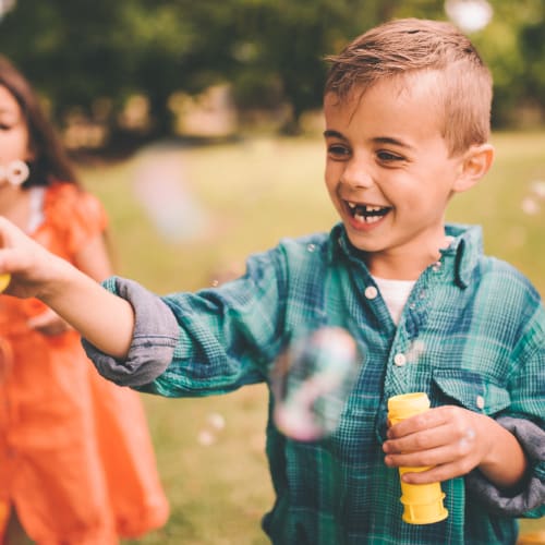 Children playing with bubbles at South Mesa II in Oceanside, California