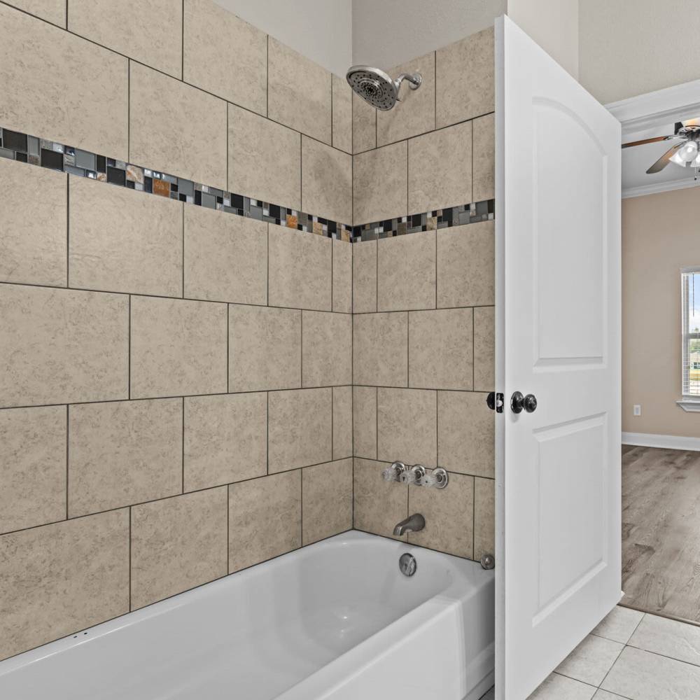 Bathroom with tub at The Arbors of Mineola in Mineola. TX