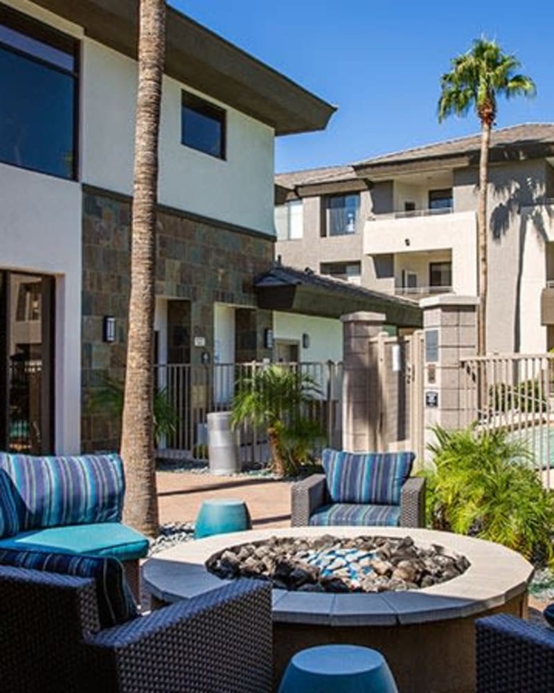 Outdoor fire pit surrounded by blue chairs at Ascent at Papago Park, Phoenix, Arizona